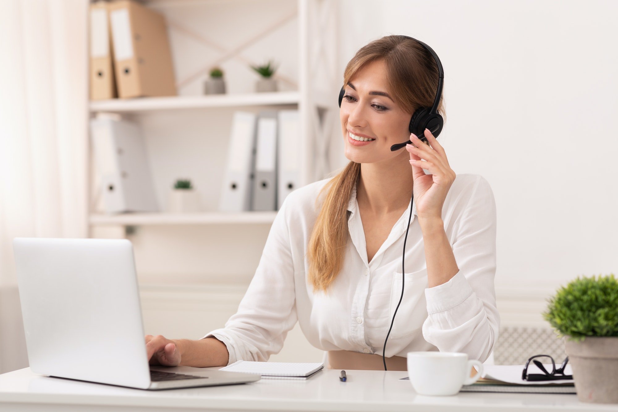 Entrepreneur Lady In Headset Making Video Call Sitting In Office
